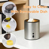 A silver electric wax melt heater is shown with a removable dish and a yellow wax melt.