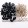 A collection of black and beige plastic safety eyes with locking washers for amigurumi projects.