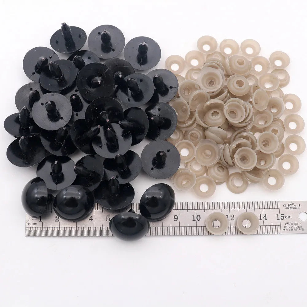 A collection of black and beige plastic safety eyes with locking washers for amigurumi projects.