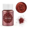 A glass jar of reddish-pink pearl powder labeled Red Wine with a circular swatch of the pigment and scattered powder.