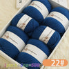 A box filled with six skeins of blue wool yarn for knitting, labeled as 1 pack equals 500g.