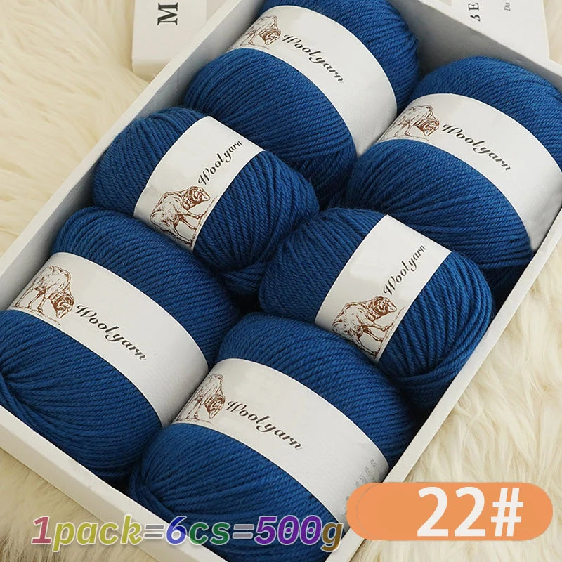 A box filled with six skeins of blue wool yarn for knitting, labeled as 1 pack equals 500g.