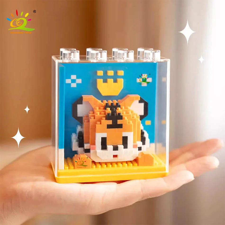 A hand holds an adorable panda micro building blocks set with a clear display box and yellow base.