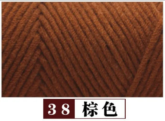 Close-up texture of brown premium milk cotton yarn used for knitting or crafting.