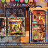 A colorful 3D wooden book nook kit featuring a detailed diorama with LED lighting and miniature scenes.