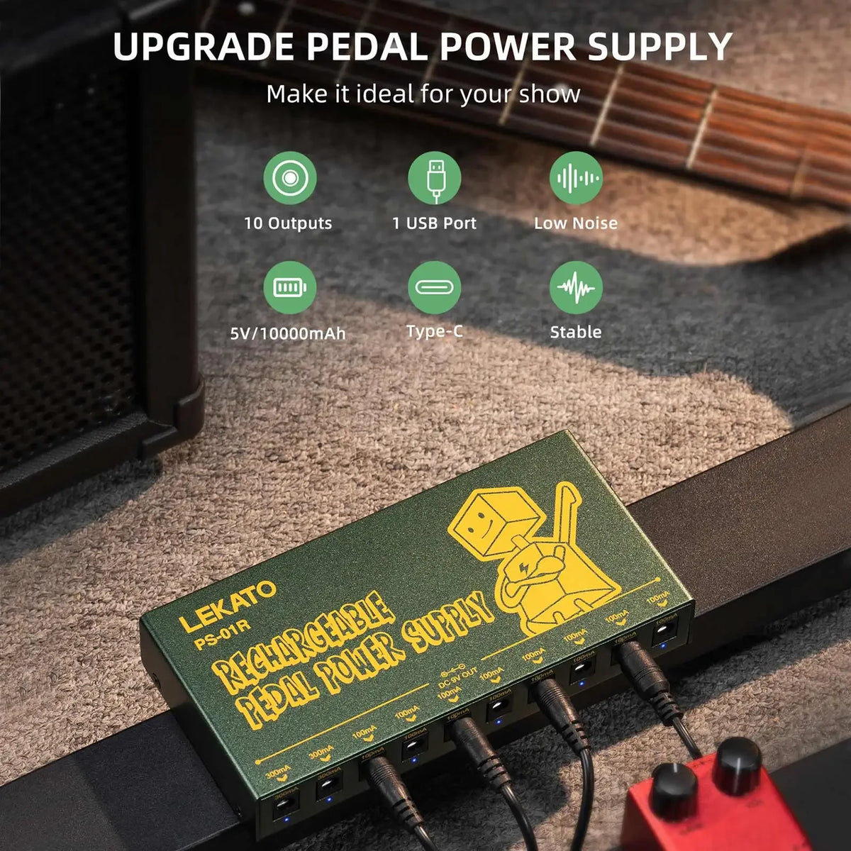 A green portable rechargeable guitar pedal power supply with multiple DC outputs is shown on a wooden surface.