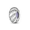 A sterling silver charm bead with a twisted design featuring small clear stones and a purple accent.