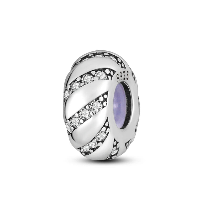 A sterling silver charm bead with a twisted design featuring small clear stones and a purple accent.