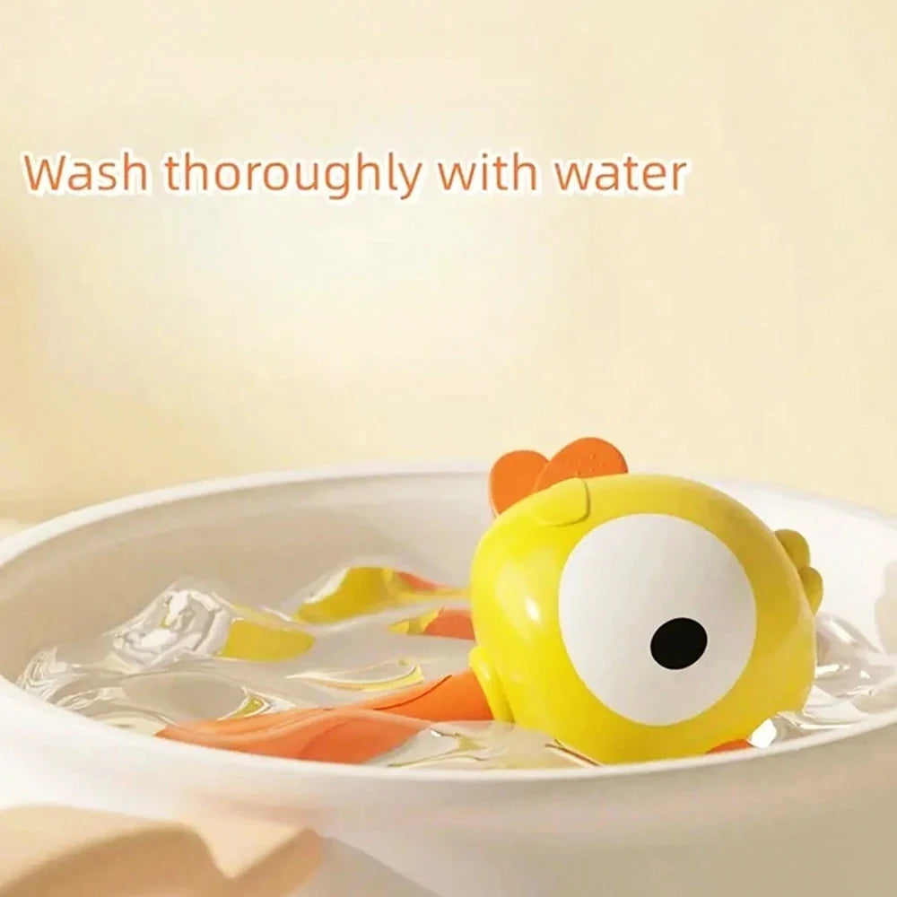 A yellow newborn sensory rattle toy is shown floating in water, with text instructing to wash thoroughly.