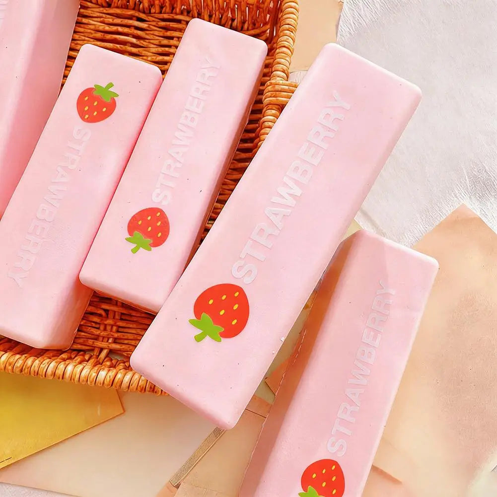 Pink strawberry milk squishy stress relief toys are displayed in a woven basket.