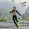 A black doll figure with gold accents is shown in a standing pose against a blurred outdoor background.