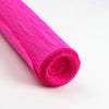 A roll of bright pink crepe paper for DIY crafts and gift wrapping.