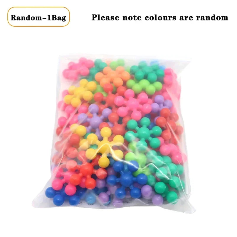 A clear plastic bag filled with a random assortment of colorful interlocking plastic building blocks