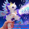 A hand holds a white unicorn-shaped bubble maker gun with purple accents and colorful light effects against a dark blue backg
