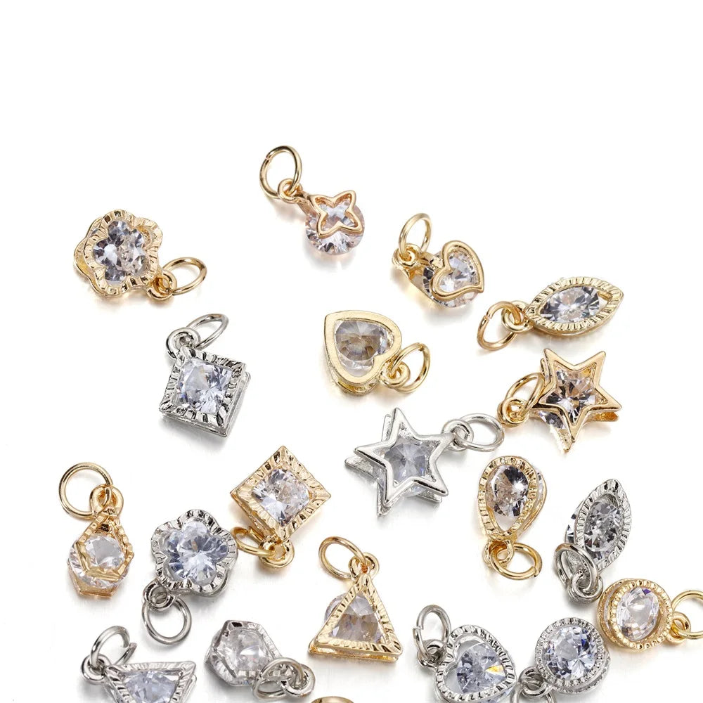 A collection of gold and silver rhinestone heart charms for jewelry making.