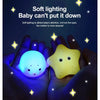 A pair of hands holds a glowing yellow light-up toy for babies against a dark background.