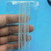 A clear plastic bag contains a set of transparent ring size adjusters or rings.