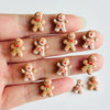 A hand displays a set of 30 gingerbread resin nail art charms for DIY decoration.