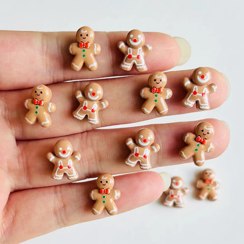 A hand displays a set of 30 gingerbread resin nail art charms for DIY decoration.