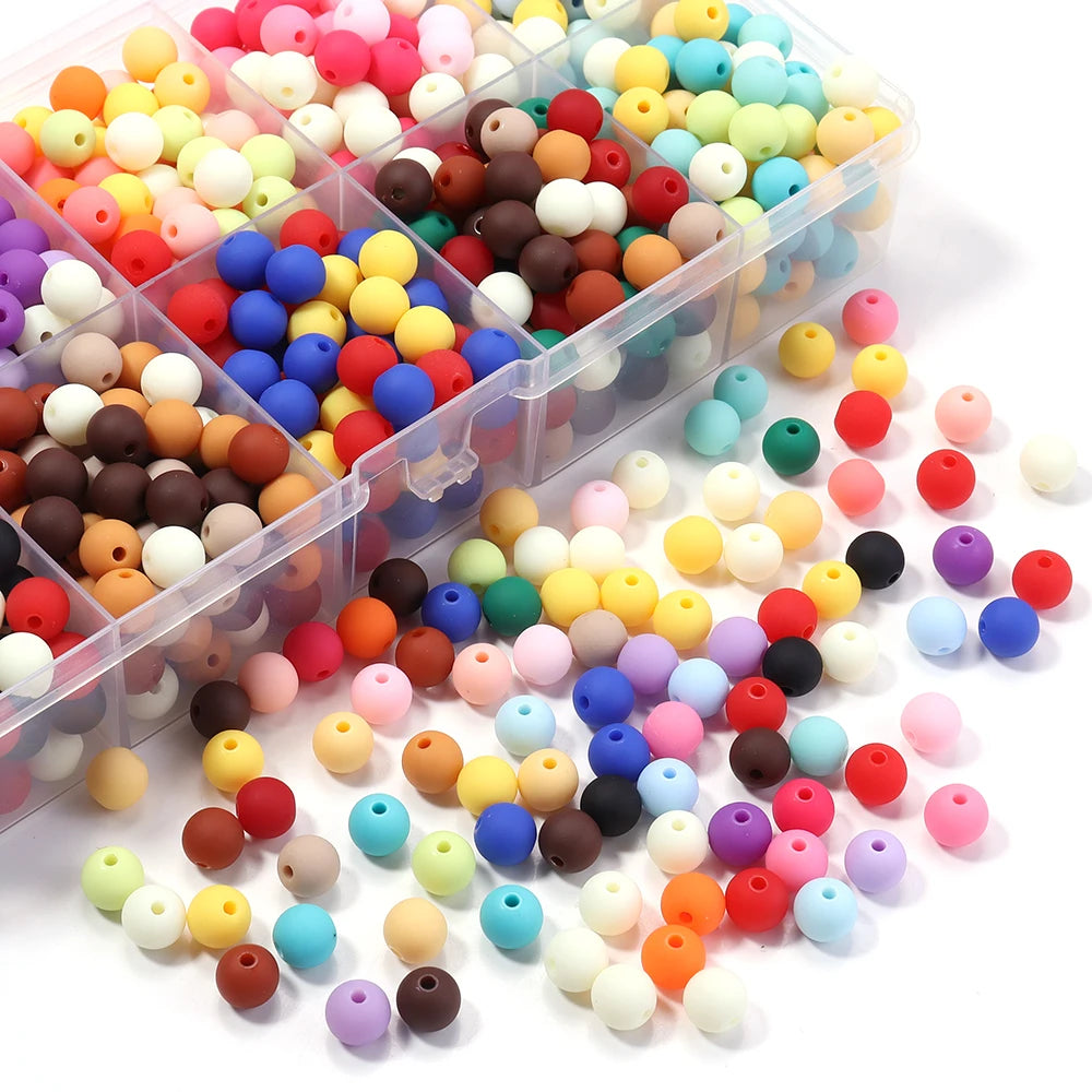 A variety of matte acrylic beads in various colors like pink, yellow, blue, and brown are displayed in clear plastic containe