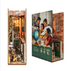 A DIY book nook kit featuring a detailed brick facade with an interior scene and LED lighting.