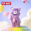 A purple Care Bear plush toy standing on a surface with pink and white clouds and balloons.