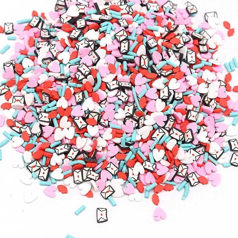 A pile of colorful polymer clay flower charms in various shades of pink, red, white, and blue.