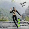 A black plush doll resembling Elvis Presley in a suit is shown against a blurred outdoor background.
