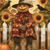 A carved jack-o'-lantern face wearing a plaid coat sits behind a white picket fence surrounded by autumn leaves and sunflower