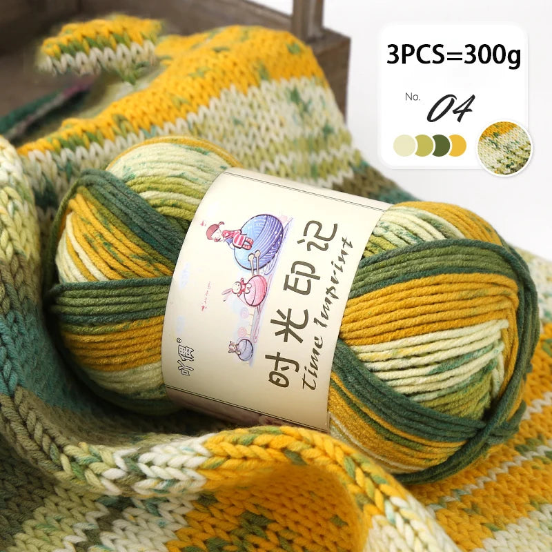 A ball of yellow and green gradient acrylic yarn is shown on a knitted fabric, with a label indicating the yarn type.
