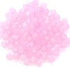 A pile of small, round, faceted pink glass beads for jewelry making.