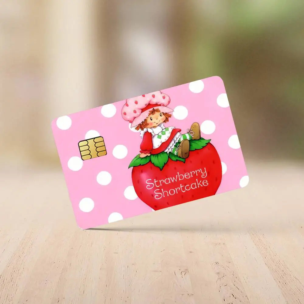 A pink card featuring a strawberry shortcake cartoon illustration on a white background.