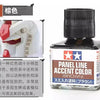 A bottle of Panel Line Accent Color enamel paint in brown, showing the product label and applicator tip.