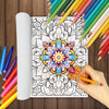 An open coloring book page featuring a detailed mandala design surrounded by colored pencils and crayons.