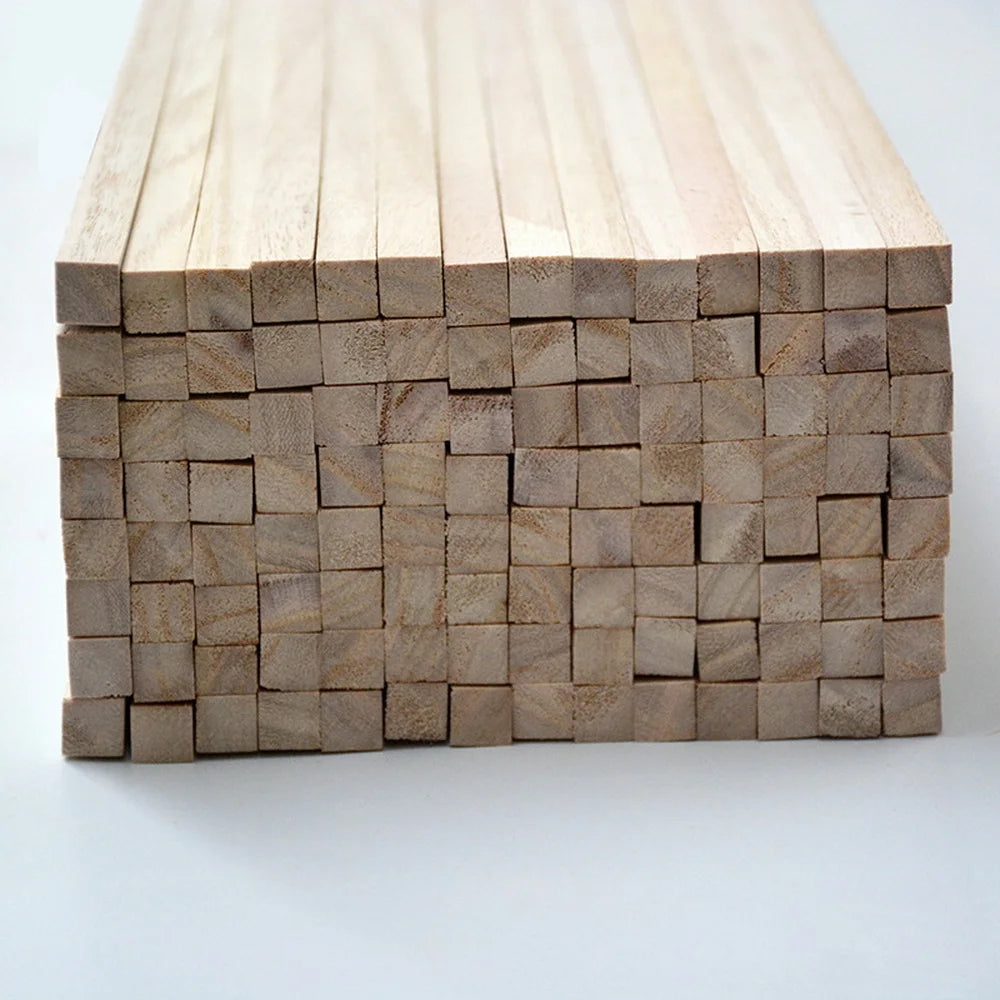 A stack of natural solid wood strips for DIY crafts and model building, showing various thicknesses.