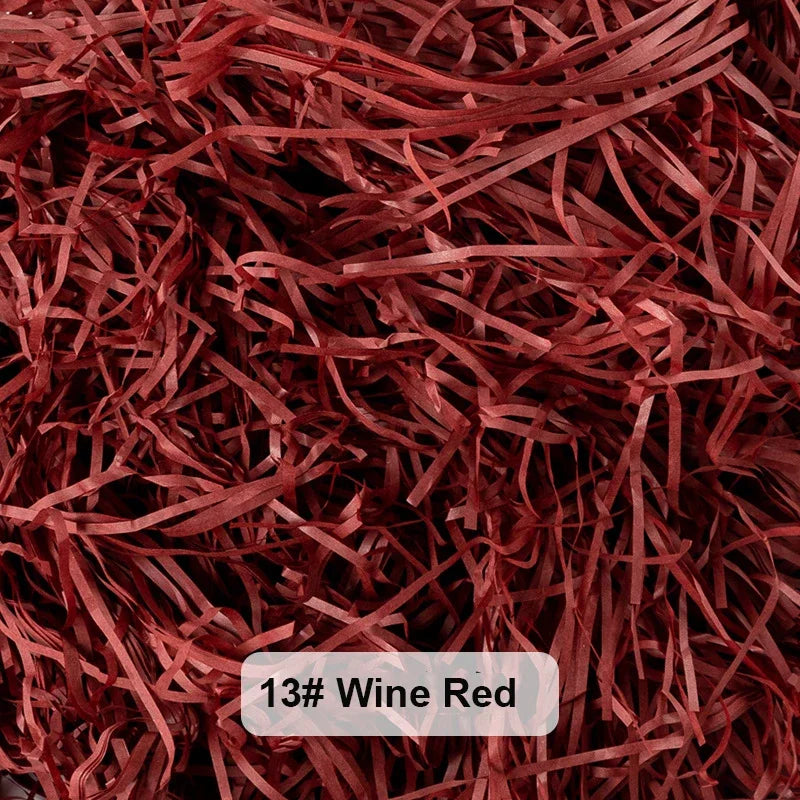 A close-up view of reddish-brown raffia paper shreds used for gift boxes and baskets.