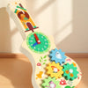 A wooden Montessori busy board featuring musical and sensory activities for children.