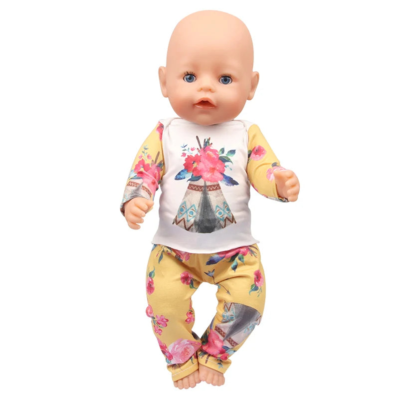 A baby doll wearing a floral unicorn pajama set with pink and yellow patterns.