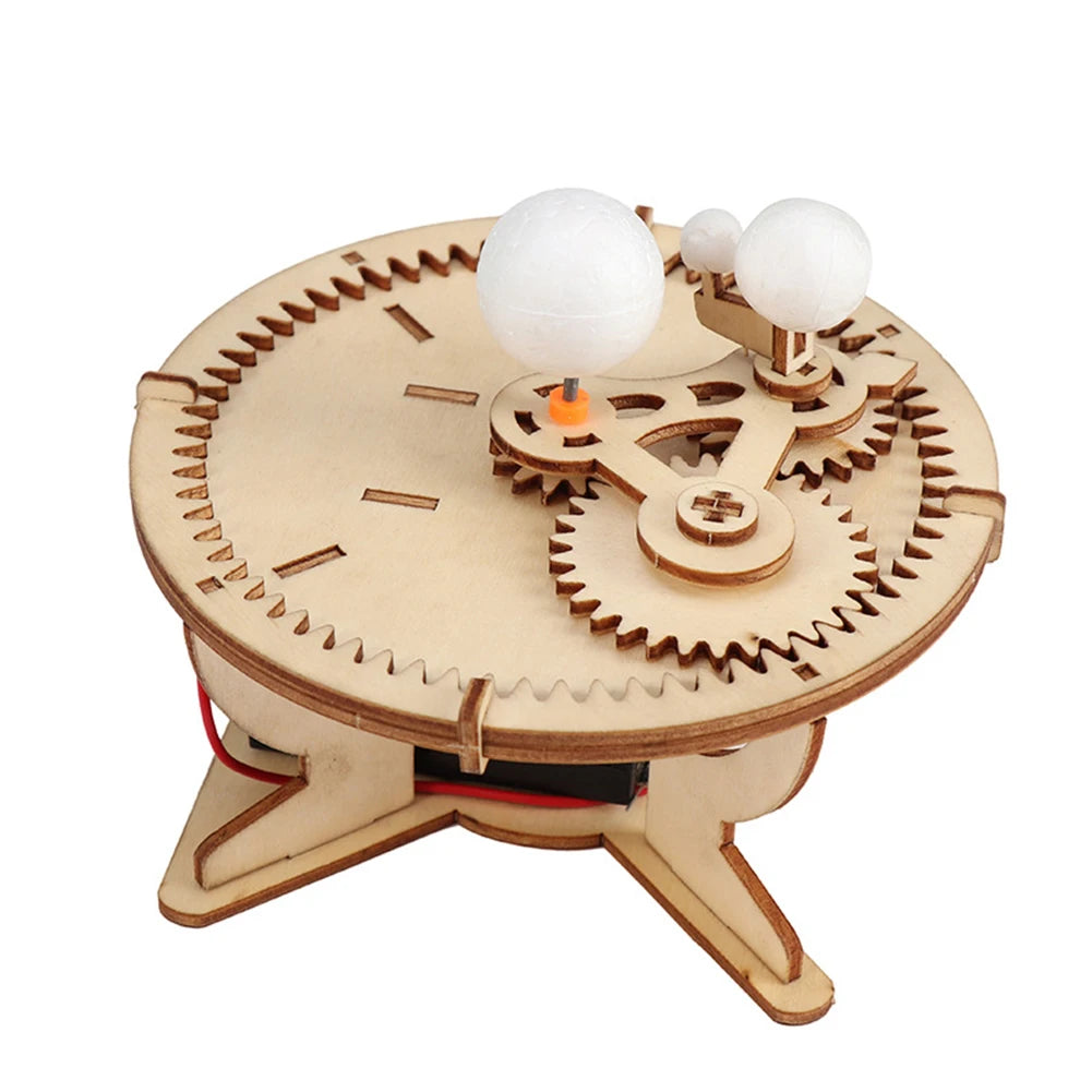A wooden paddle boat kit featuring a propeller and two white spheres, designed for a DIY science experiment.