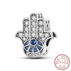 Sterling silver hand sign charm with blue evil eye design and small cross beads