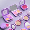 A collection of purple and pink cosmetic products including palettes, compacts, and loose powder in an open case.