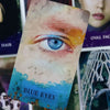 A close-up of an oracle card featuring a detailed blue eye and the text BLUE EYES.