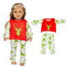 A doll wearing a red shirt with a green deer design, white pants, and green leafy tights.