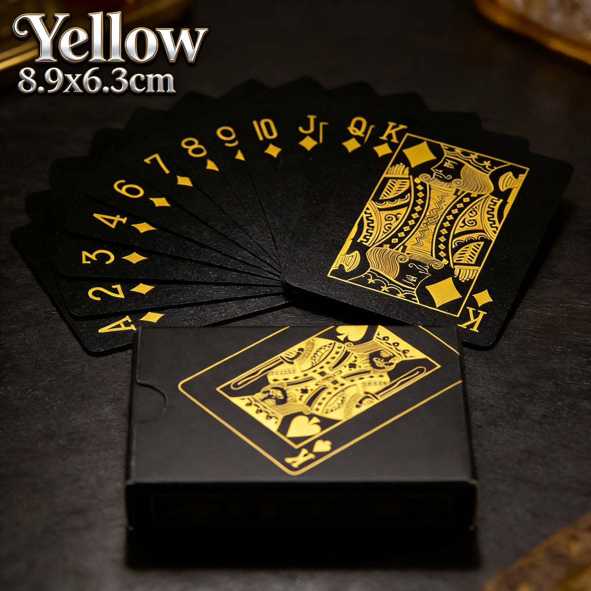 A deck of yellow playing cards with a gold border is shown next to a box.
