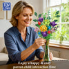 A smiling woman holds a colorful bouquet of flowers and greenery, suggesting a happy parent-child interaction time.