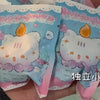 A hand holds a package of cute mini bean blind box figurines featuring strawberry mousse tower and octopus cat pendant charms