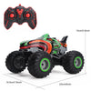 A green and orange All-Terrain RC monster truck with large tires and a remote control transmitter.