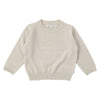 A light beige knit sweater and matching pants set for a toddler.