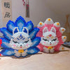 A set of nine-tailed fox figures made from blue and pink building blocks.