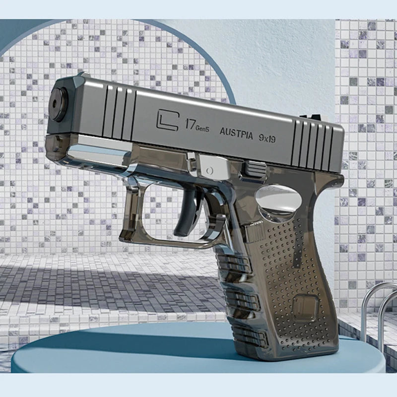 A silver high-power water blaster gun is displayed on a light blue surface against a textured background.